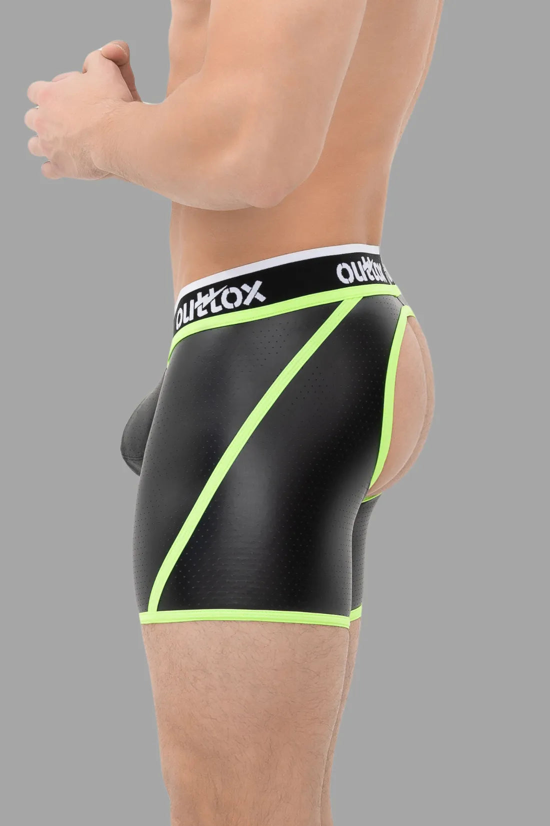 Outtox. Shorts mit offenem Rücken und Druckknopf-Codpiece. Schwarz und Grün „Neon“