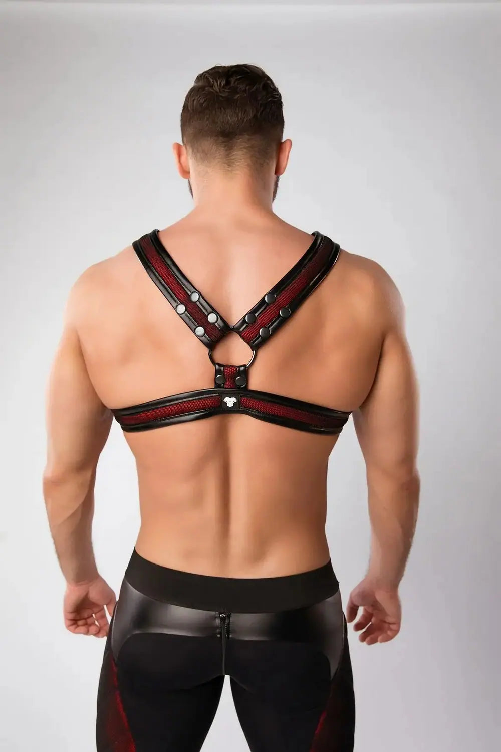 Maskulo Armored Color-Under red chest X-harness for men, with black mesh and leather piping, styled for Gen Z urban and gender-fluid expression