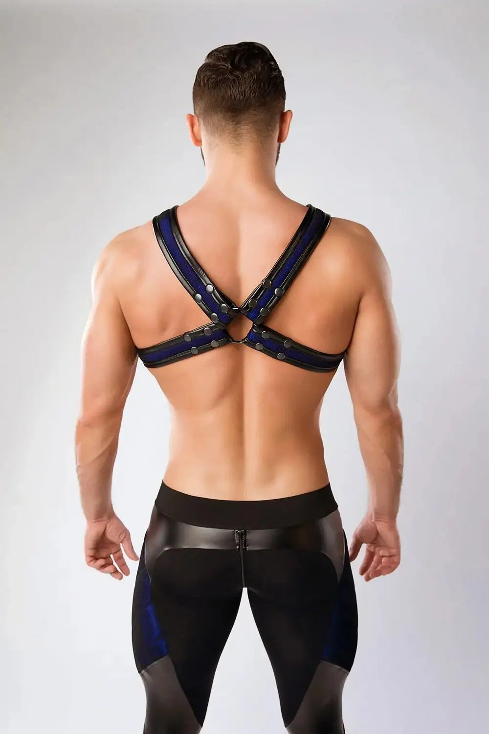 Maskulo Armored Color-Under royal blue chest X-harness for men, featuring black mesh, shiny PU leather piping, ideal for gym or party wear