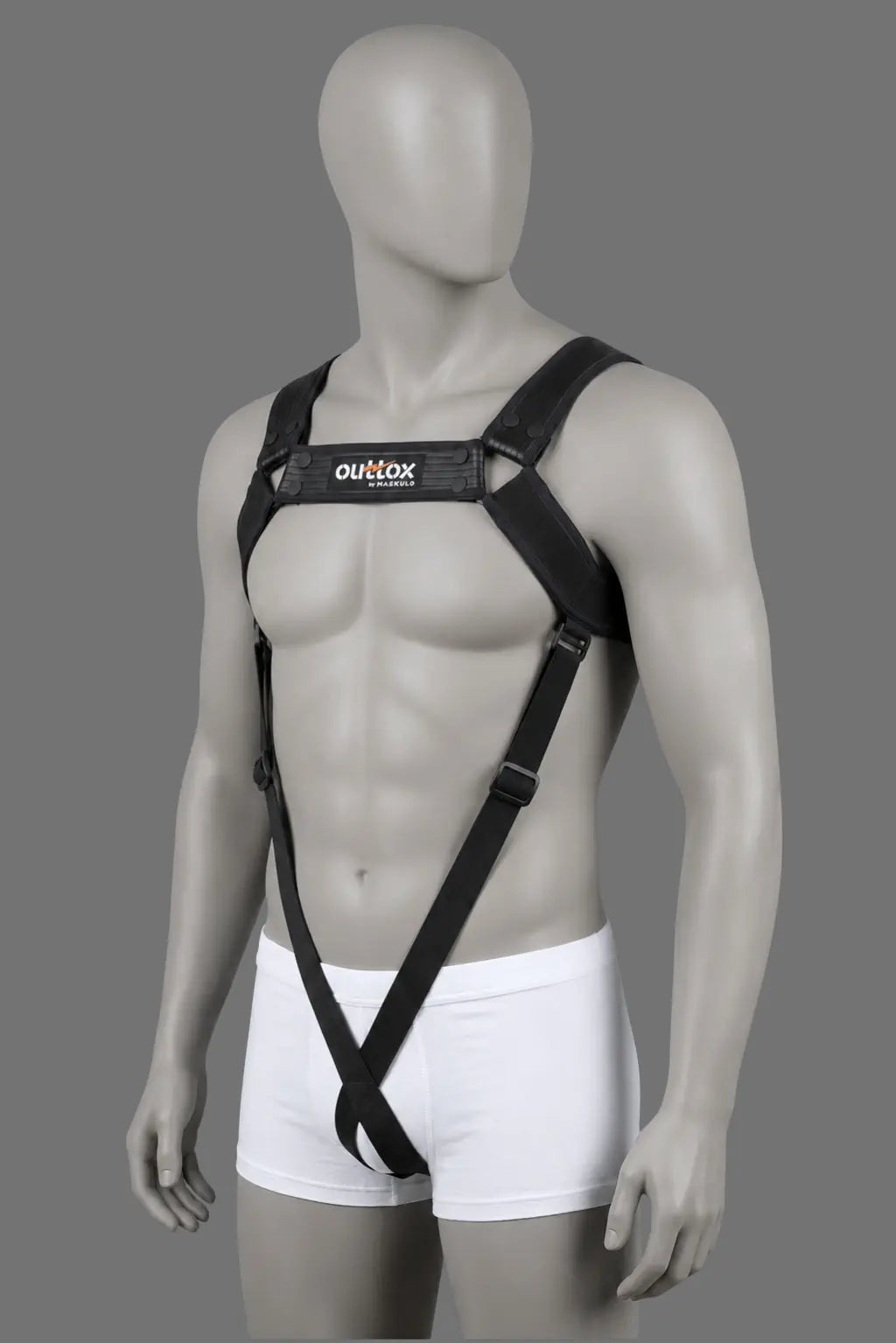 Outtox Harness XHR120 in black. Maskulo Europe. Features stretch PU leather straps, adjustable snap buttons, and visually slimming elastic front bands going down to form a loop